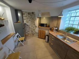 a kitchen with a sink and a counter top at Ισόγειο διαμέρισμα με κήπο. Special design! in Kastoria +8 photos