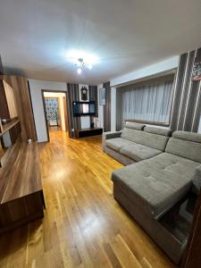 a living room with a couch and a table at Debo Apartament in Lugoj