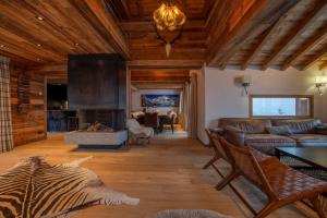 a living room with a couch and a fireplace at Chalet Chardon Bleu in Méribel