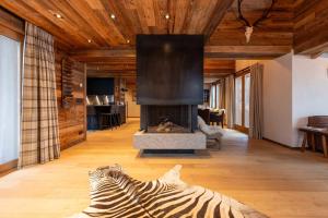 a living room with a fireplace and a zebra statue at Chalet Chardon Bleu in Méribel