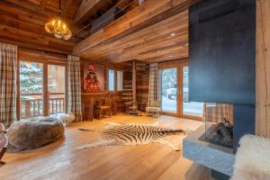 a zebra laying on the floor in a room with a fireplace at Chalet Chardon Bleu in Méribel