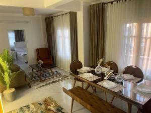 a living room with a wooden table and chairs at Tony HOUSE in Aswan