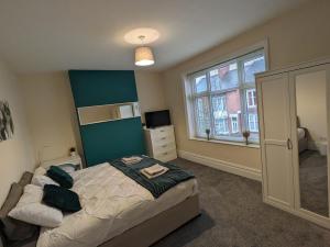 a bedroom with a bed and a large window at Beacon House in Leicester