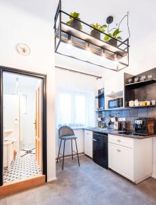 a kitchen with a table and a chair in it at Silvie Apartments - Lazecká in Olomouc