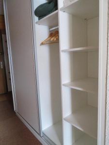 a white refrigerator freezer with its door open at Val Thorens Studio Cabine 2 Adultes et 2 Enfants Wifi in Val Thorens