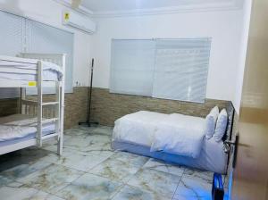 a bedroom with two bunk beds and a window at 7 Palms Bungalow in Accra
