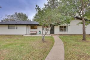 a white house with a sidewalk in front of a yard at Spacious Bryan Home with Patio 4 Mi to Downtown in Bryan