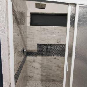 a bathroom with a shower with a glass door at Bonito departamento in Morelia