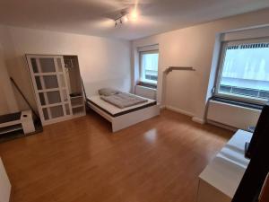 an empty room with a bed and a window at City Central Apartment in Kaiserslautern