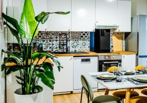 a kitchen with a table and a potted plant at OASIS - 10 min from Disney, Free Parking, Self-Checkin in Montévrain