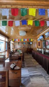 a restaurant with colorful flags hanging from the ceiling at Hotel Lake view in Nako +27 photos