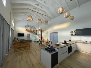 a large kitchen and living room with a table at Coastal Cove in St Helena Bay