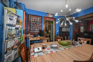 a dining room with a wooden table and a refrigerator at Berrodin Bed & Breakfast in Akron
