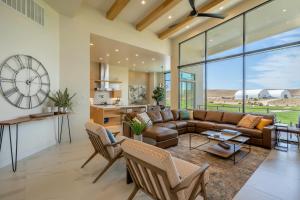 a living room with a couch and a clock at Live Luxurious at Zion in Hurricane