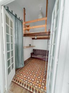 a room with a couch on a tiled floor at BBTK Bed and Bike in Málaga