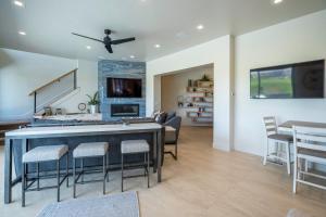 a kitchen and living room with a bar and chairs at Live Luxurious at Zion in Hurricane