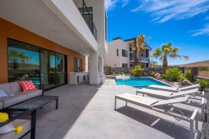 a patio with lounge chairs and a swimming pool at Live Luxurious at Zion in Hurricane