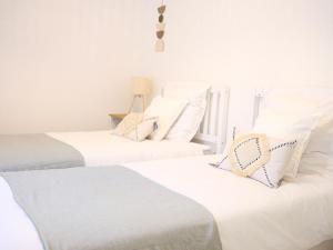 two white beds in a room with white walls at OASIS - 10 min from Disney, Free Parking, Self-Checkin in Montévrain