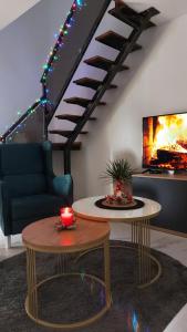 a living room with a couch and a fireplace at House_Zoi in Čelinac