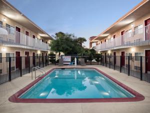 a swimming pool in the courtyard of a building at Dream Inn in Fresno