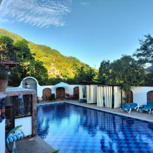 a swimming pool with a mountain in the background at Amaria Villas in Puerto Vallarta