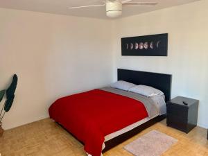 a bedroom with a bed with a red blanket at New ATL Dwntwn Condo with Balcony 2 in Atlanta