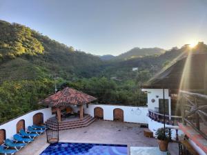 a resort with a pool and a view of a mountain at Amaria Villas in Puerto Vallarta