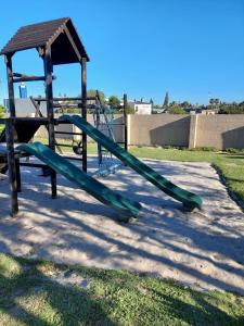 a playground with a green slide in a park at Serendip@sea in Cape Town