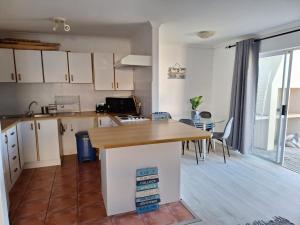 a kitchen with a wooden counter top in a room at Serendip@sea in Cape Town