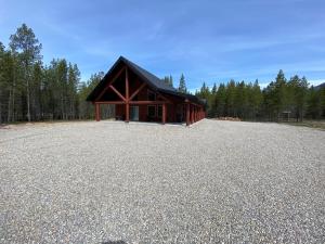a large gravel parking lot in front of a cabin at Overlook in Valemount