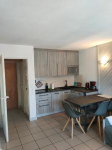 a kitchen with a table and a table and chairs at Chez Maxime Pre du Moulin in Briançon