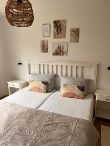 a bedroom with a white bed with two pillows at Große Apartments für Monteure - Dorsten - in Dorsten +8 photos