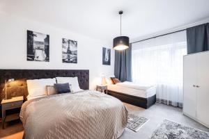 a bedroom with a large bed and a couch at Silvie Apartments - Lazecká in Olomouc