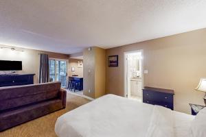 a hotel room with a bed and a couch at Condo 503 at North Creek Resort in Blue Mountains +21 photos
