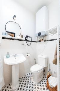 a white bathroom with a toilet and a sink at Silvie Apartments - Lazecká in Olomouc