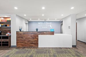 a welcoming lobby with a white counter and a welcome sign at Hampton Inn Los Angeles Airport in Los Angeles