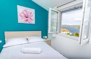 a bedroom with a bed and a large window at Apartments Katic in Ražanj +76 photos