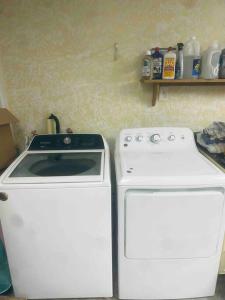 a kitchen with a stove and a washing machine at Holistic Gem w/1Gig Wi-Fi & free parking in Houston