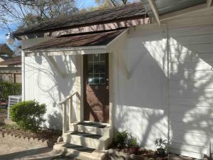 a white house with a front door and stairs at Holistic Gem w/1Gig Wi-Fi & free parking in Houston
