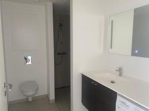 a white bathroom with a toilet and a sink at Quantum dimension in Rødovre