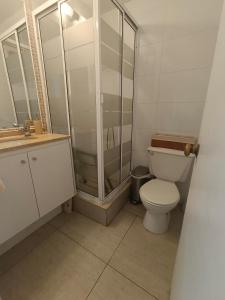 a bathroom with a toilet and a glass shower at Sector San Martin in Viña del Mar