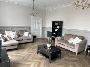 a living room with two couches and a coffee table at No.8 Laura Place in Aberystwyth