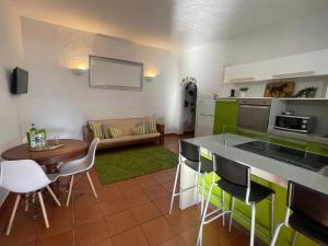 a kitchen and living room with a table and chairs at Bed&Ride La Manigua in Ojos de Garza