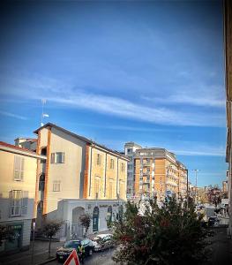 a group of buildings in a city with cars parked at Civico 31 in Vercelli