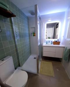 a bathroom with a toilet and a shower and a sink at Top-Floor Beachfront Apartment with Parking, Pool, & Beautiful Sea-View Balcony in Villajoyosa