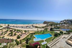 an aerial view of a resort with a swimming pool and a beach at Top-Floor Beachfront Apartment with Parking, Pool, & Beautiful Sea-View Balcony in Villajoyosa