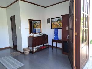 a living room with a dresser and a mirror at Palmera Palma Garden Level in Moalboal