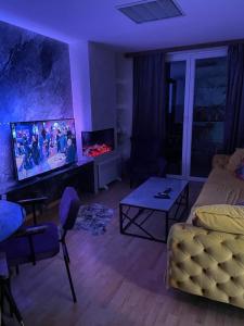 een woonkamer met een bank en een tv bij Apartman Monti Vlašić in Vlasic