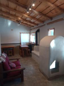 a living room with a couch and a table at Anacrusa Hostel in Epuyén