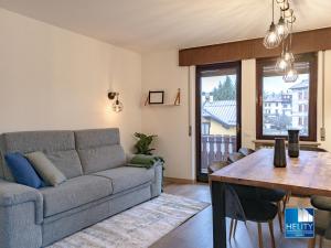 a living room with a couch and a table at [Asiago Centre] New Modern House in Asiago